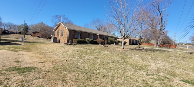 single story home with a front lawn and brick siding