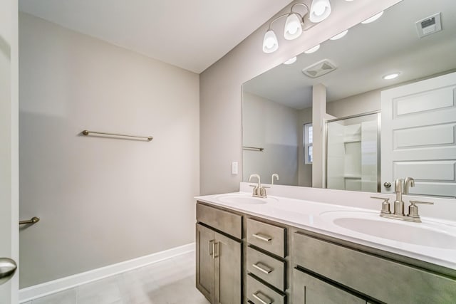 bathroom featuring visible vents, a sink, and a shower stall