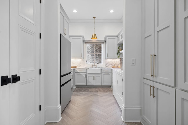 kitchen with pendant lighting, tasteful backsplash, recessed lighting, a sink, and fridge