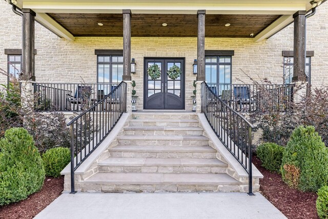 property entrance featuring french doors and a porch