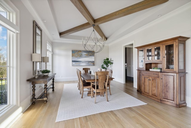 dining area with light wood-type flooring, a healthy amount of sunlight, baseboards, and beam ceiling