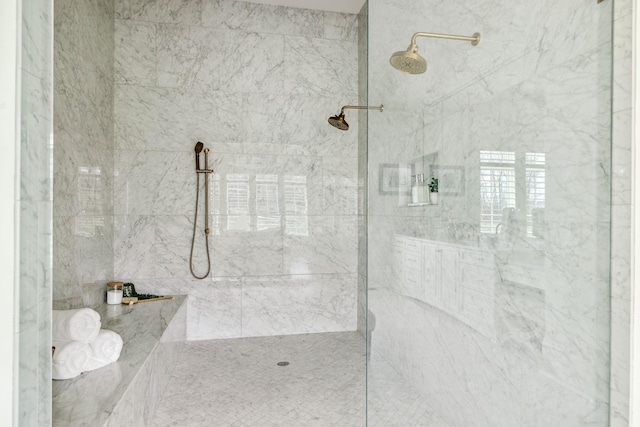 full bathroom featuring a marble finish shower