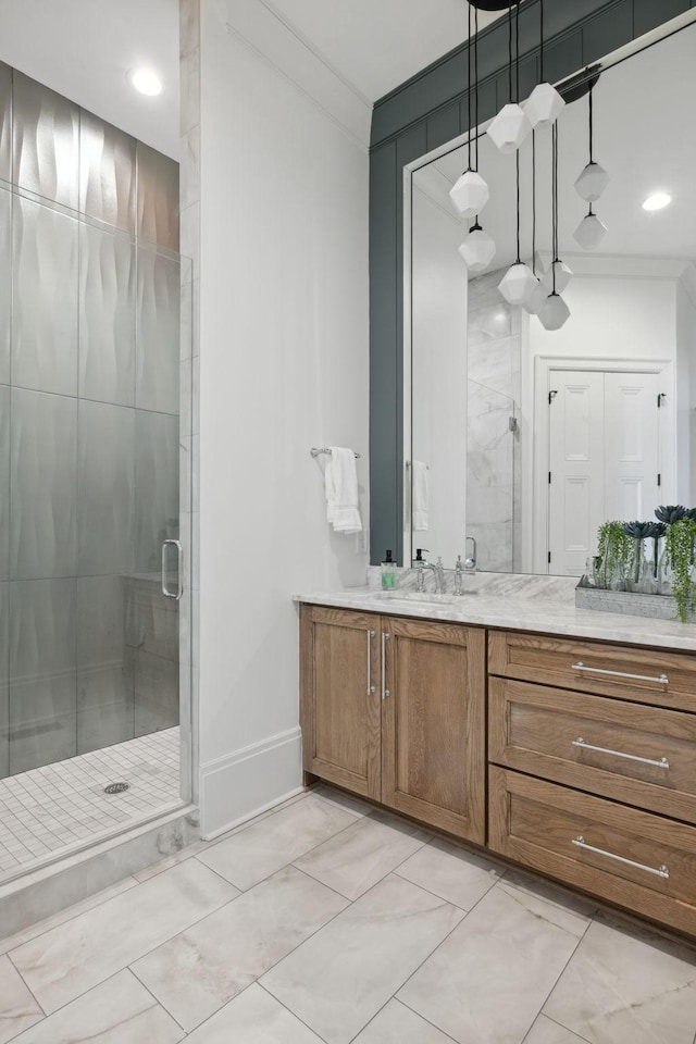 bathroom featuring a stall shower, crown molding, vanity, and baseboards