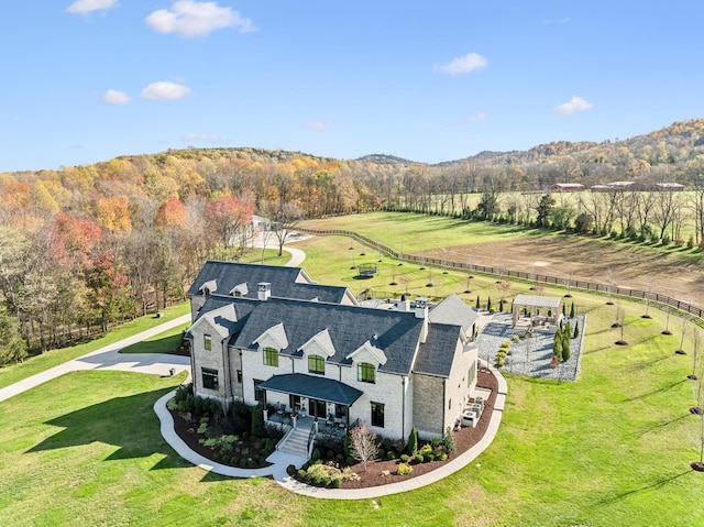 birds eye view of property with a forest view