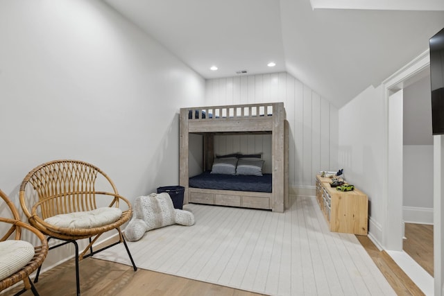 sitting room featuring lofted ceiling, recessed lighting, wood finished floors, visible vents, and baseboards