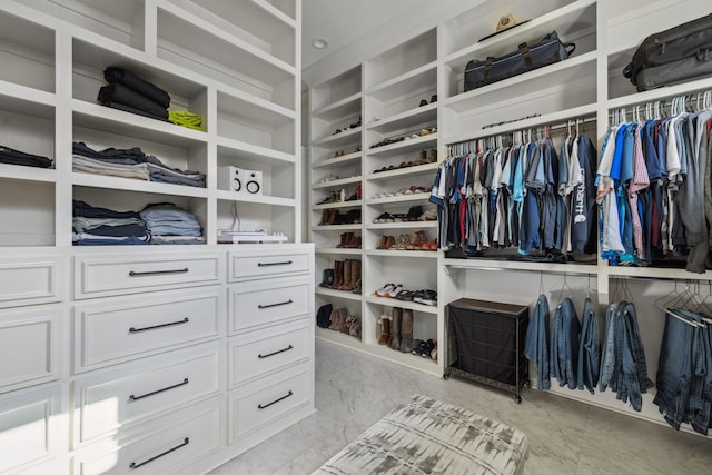 spacious closet with marble finish floor