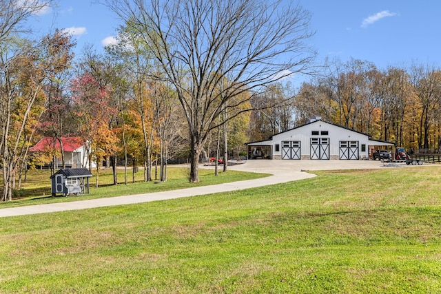 view of yard with a garage, an outbuilding, and a barn