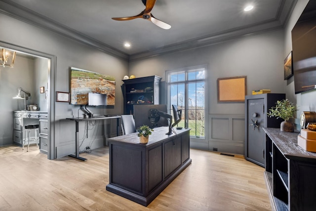 office with ceiling fan, light wood finished floors, a decorative wall, and crown molding