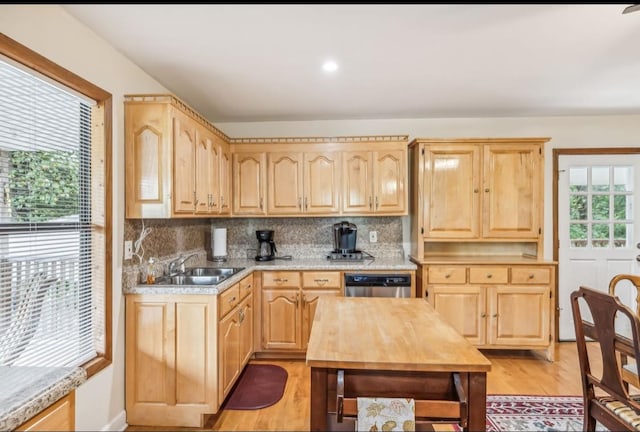 kitchen featuring light countertops, a sink, and light brown cabinetry