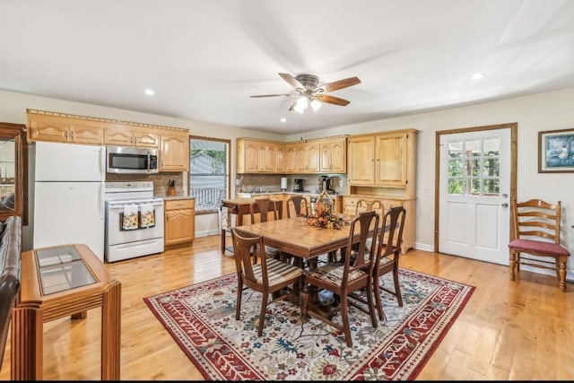 dining area featuring light wood-type flooring, a wealth of natural light, baseboards, and recessed lighting