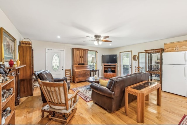 living area featuring a ceiling fan, recessed lighting, and light wood finished floors