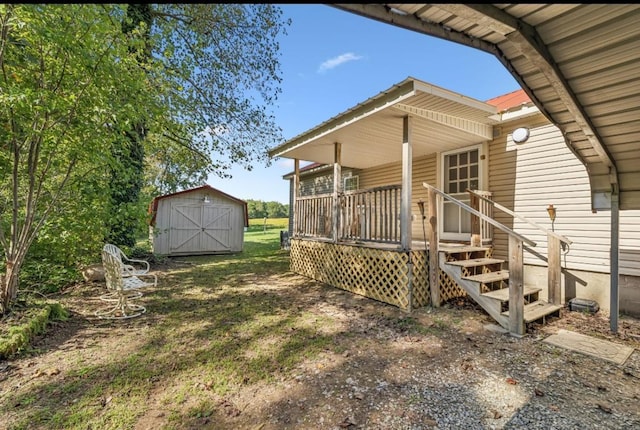 rear view of house with an outbuilding, covered porch, and a shed