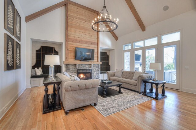 living room featuring high vaulted ceiling, beam ceiling, a fireplace, and light wood-style flooring