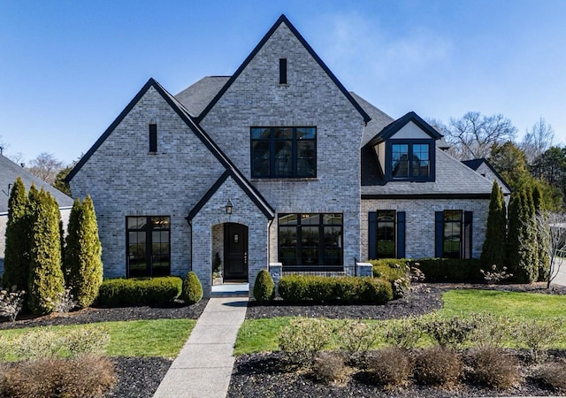 french country style house with brick siding