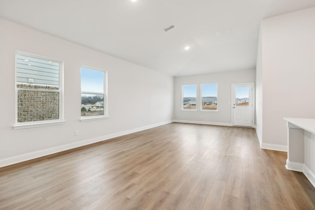 spare room featuring recessed lighting, visible vents, baseboards, vaulted ceiling, and light wood finished floors