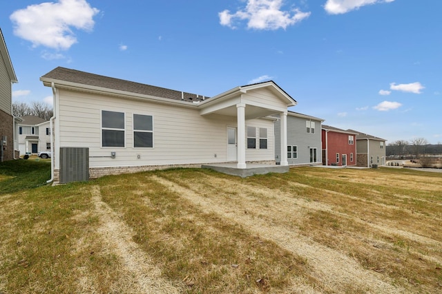 back of property featuring a yard and a patio