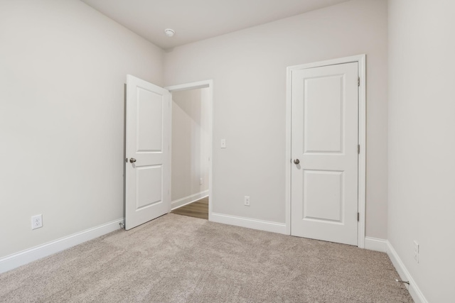 unfurnished bedroom with carpet and baseboards