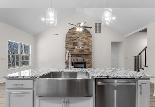 kitchen featuring hanging light fixtures, dishwasher, and wood finished floors