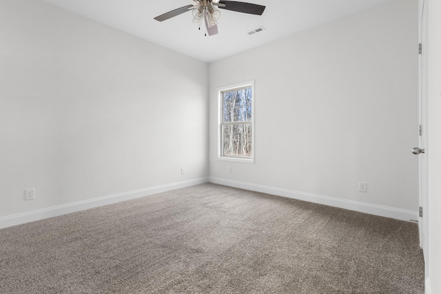 carpeted empty room featuring ceiling fan and baseboards