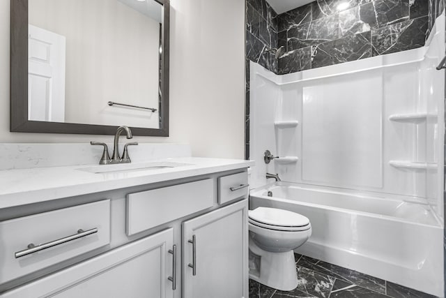 full bathroom with marble finish floor,  shower combination, vanity, and toilet