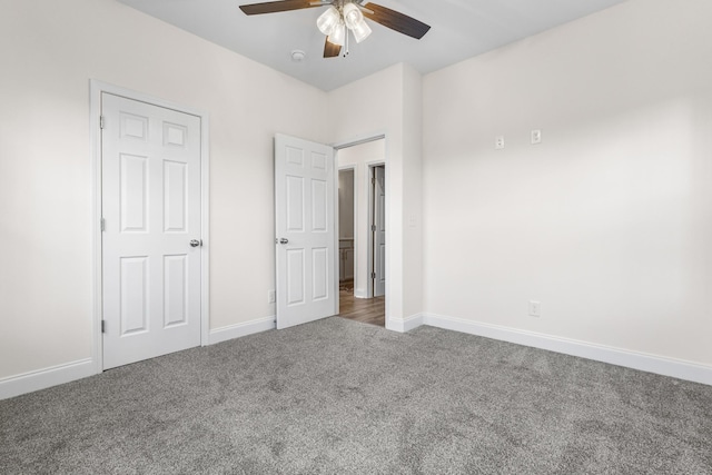 unfurnished bedroom featuring carpet floors, baseboards, and a ceiling fan