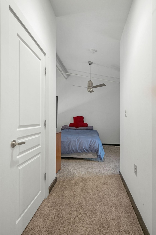 bedroom with lofted ceiling, carpet, and baseboards