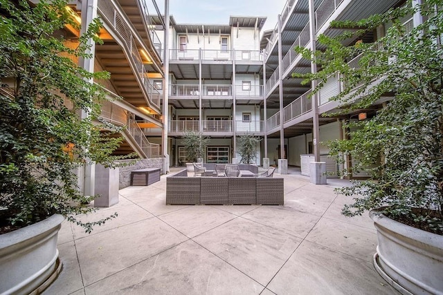 exterior space with outdoor lounge area, a patio, and stairway