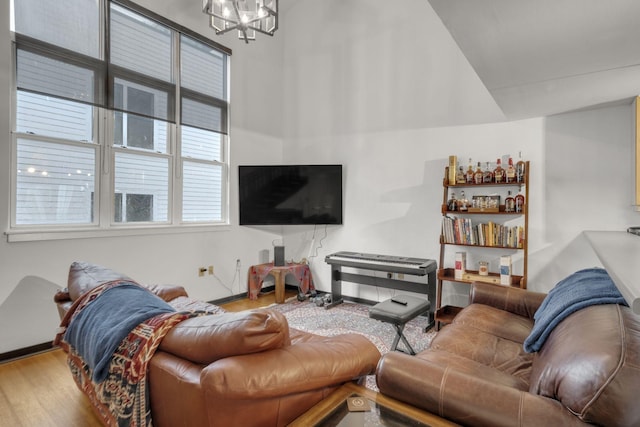 living area with wood finished floors and a notable chandelier