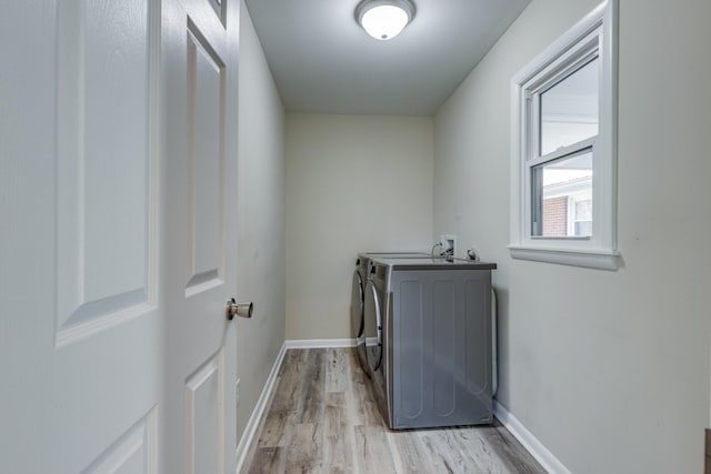 1311 Bel Aire Dr, Tullahoma, TN 37388 - clothes washing area featuring washing machine and clothes dryer, light wood finished floors, and baseboards