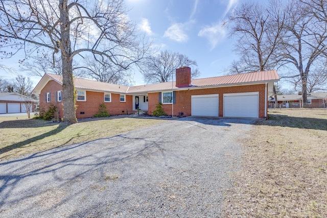 ranch-style house featuring a garage, brick siding, crawl space, and a chimney