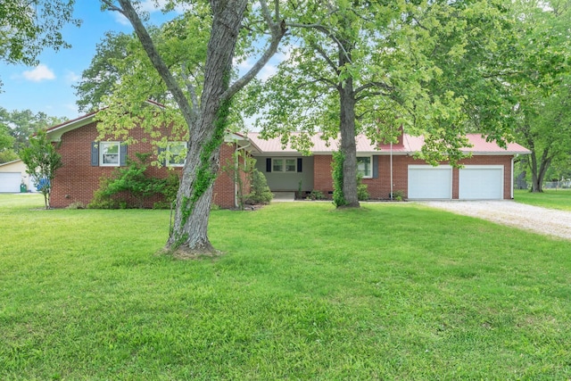 1311 Bel Aire Dr, Tullahoma, TN 37388 - ranch-style house with brick siding, dirt driveway, a garage, and a front yard