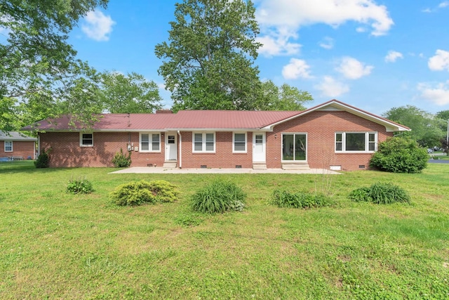 1311 Bel Aire Dr, Tullahoma, TN 37388 - rear view of property with crawl space, a lawn, a patio area, metal roof, and brick siding
