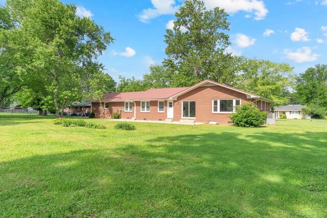 1311 Bel Aire Dr, Tullahoma, TN 37388 - rear view of property with brick siding, a lawn, and crawl space