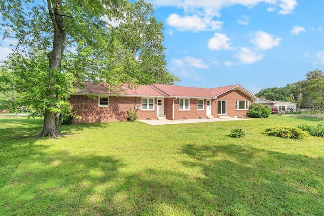 1311 Bel Aire Dr, Tullahoma, TN 37388 - back of house featuring brick siding, a yard, and a patio