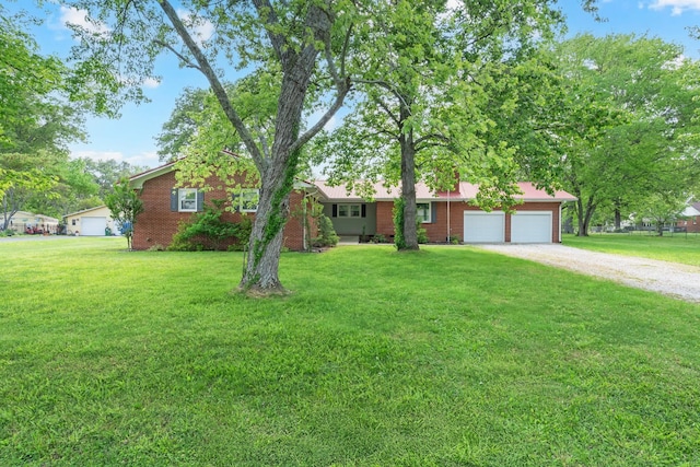 1311 Bel Aire Dr, Tullahoma, TN 37388 - single story home featuring driveway, a front yard, an attached garage, and brick siding