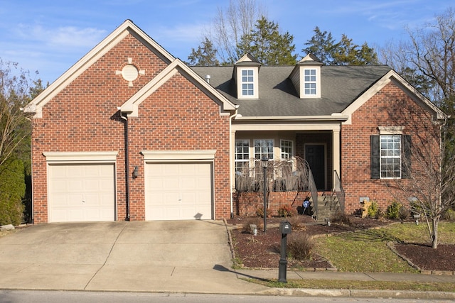 view of front of property with concrete driveway, brick siding, and an attached garage