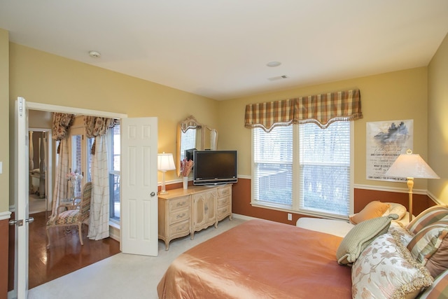 bedroom with light carpet and visible vents