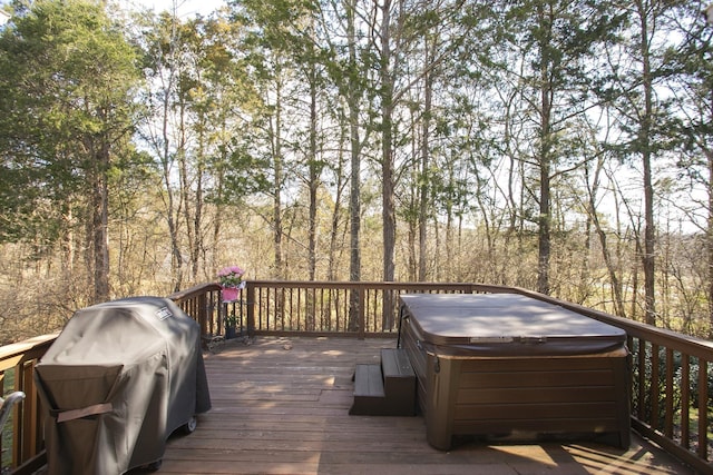 deck with a grill and a hot tub