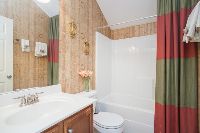 full bathroom featuring toilet, vanity, vaulted ceiling, shower / bath combination with curtain, and wallpapered walls