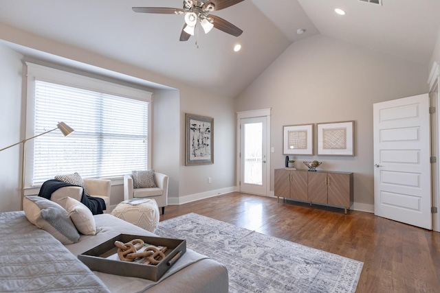 living area featuring ceiling fan, high vaulted ceiling, wood finished floors, and baseboards