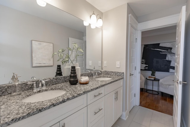 bathroom with double vanity, tile patterned flooring, and a sink