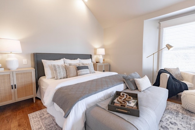 bedroom featuring lofted ceiling and wood finished floors