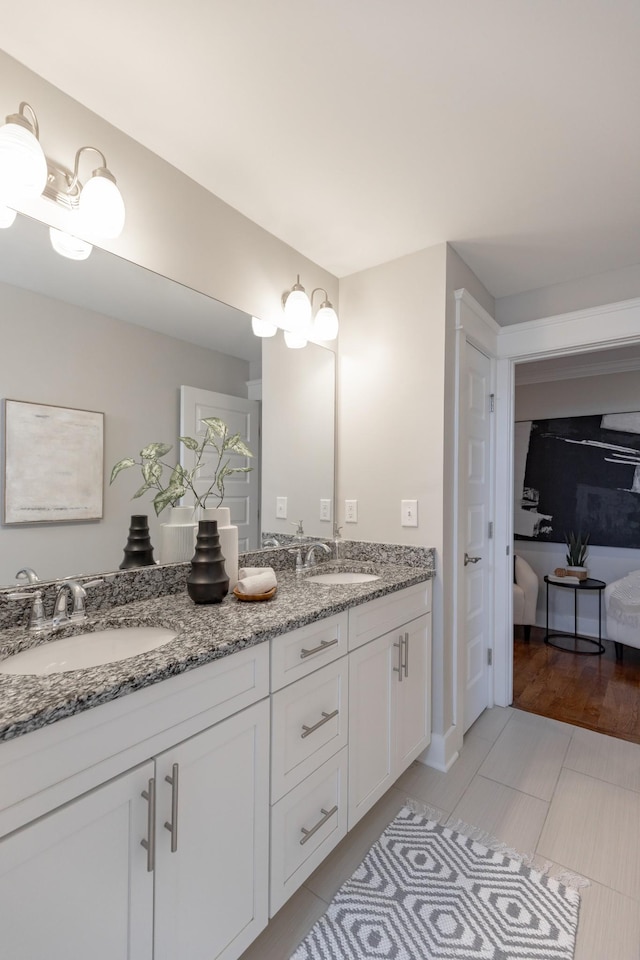 bathroom with double vanity, a sink, and tile patterned floors