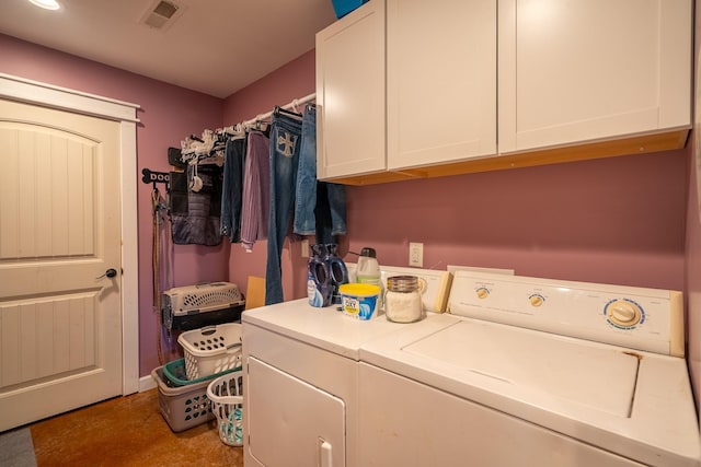 washroom featuring cabinet space, washing machine and dryer, and visible vents