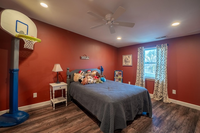 bedroom featuring visible vents, baseboards, and wood finished floors