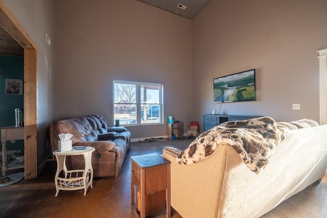 living room featuring baseboards and high vaulted ceiling