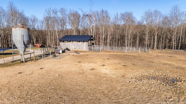 view of yard featuring an outdoor structure and fence