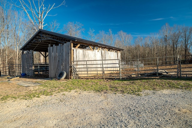 view of outbuilding featuring an outbuilding and fence