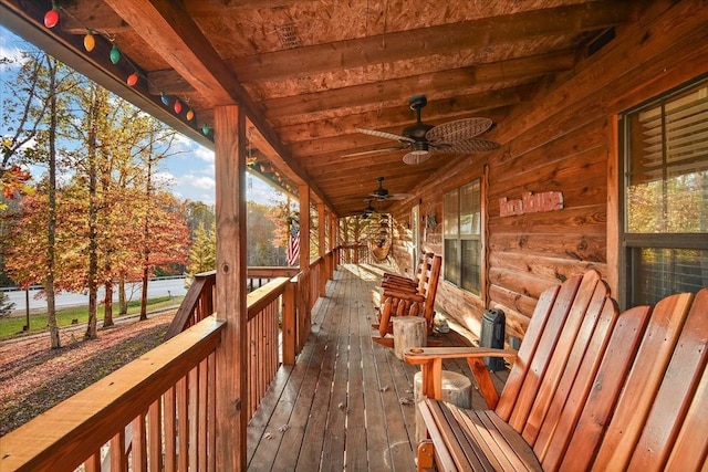 wooden deck featuring ceiling fan