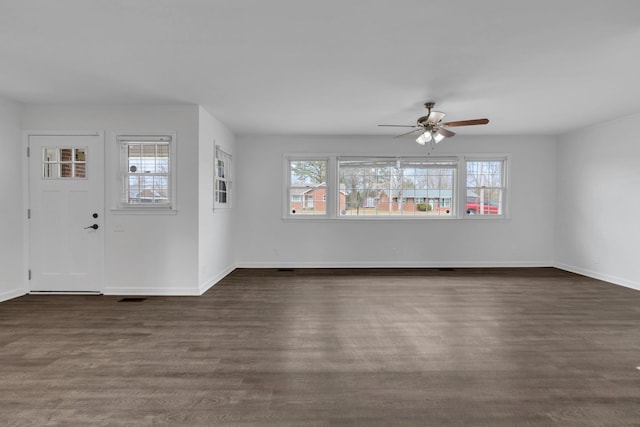 foyer entrance featuring visible vents, dark wood finished floors, a wealth of natural light, and baseboards